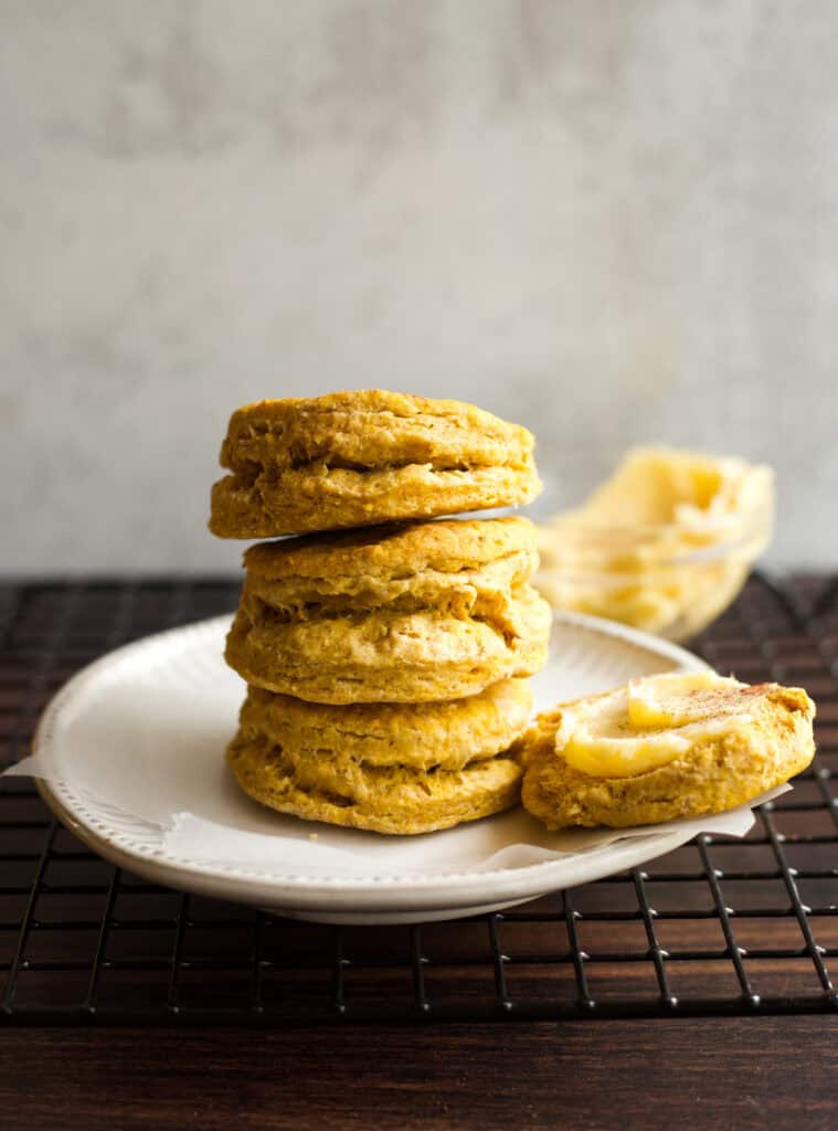 A small plate with a stack of Bisquick Pumpkin Biscuits.
