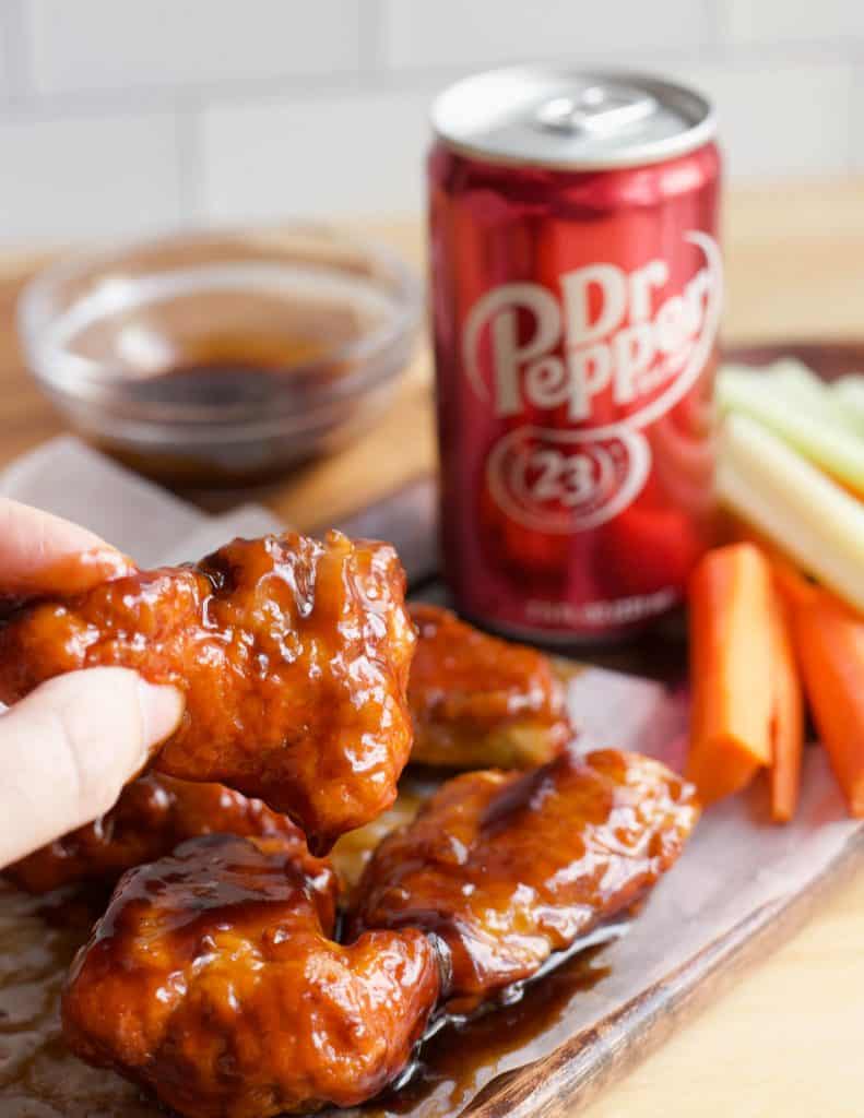 hand holding Dr Pepper Hot Wing