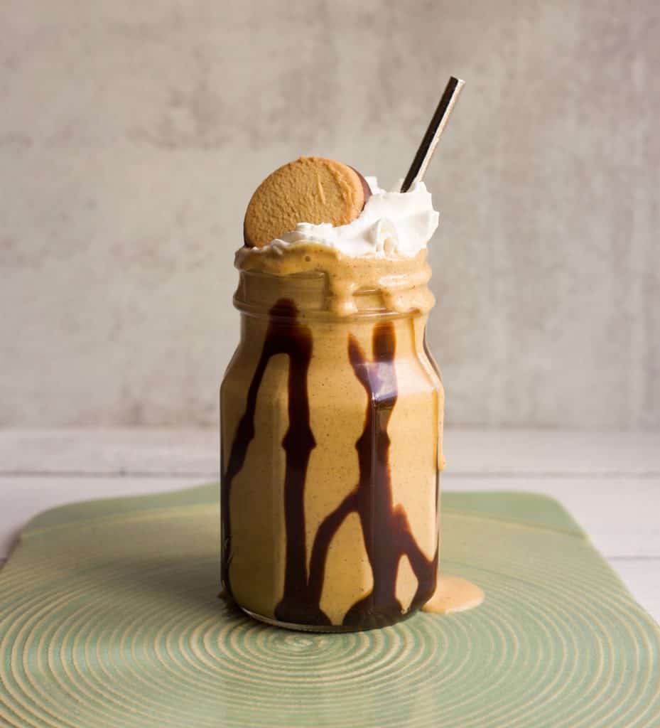 pumpkin pie protein smoothie with whipped cream and chocolate drizzle
