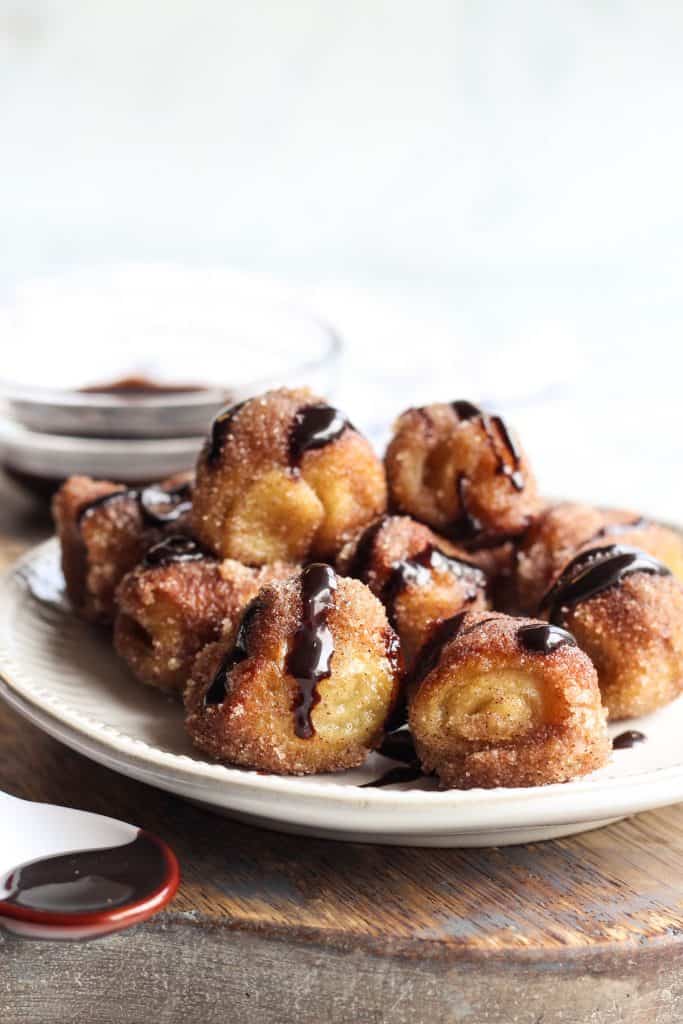 Cinnamon Sugar Pizza Dough Pretzel Bites on a plate with chocolate dipping sauce