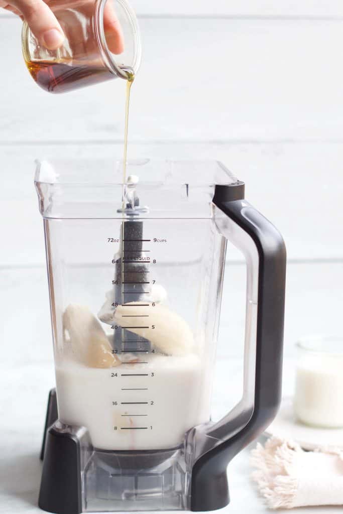 maple syrup being poured into a blender