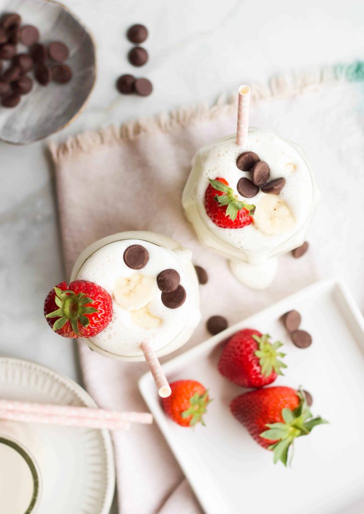 Banana Greek Yogurt Smoothies topped with chocolate chips and banana slices