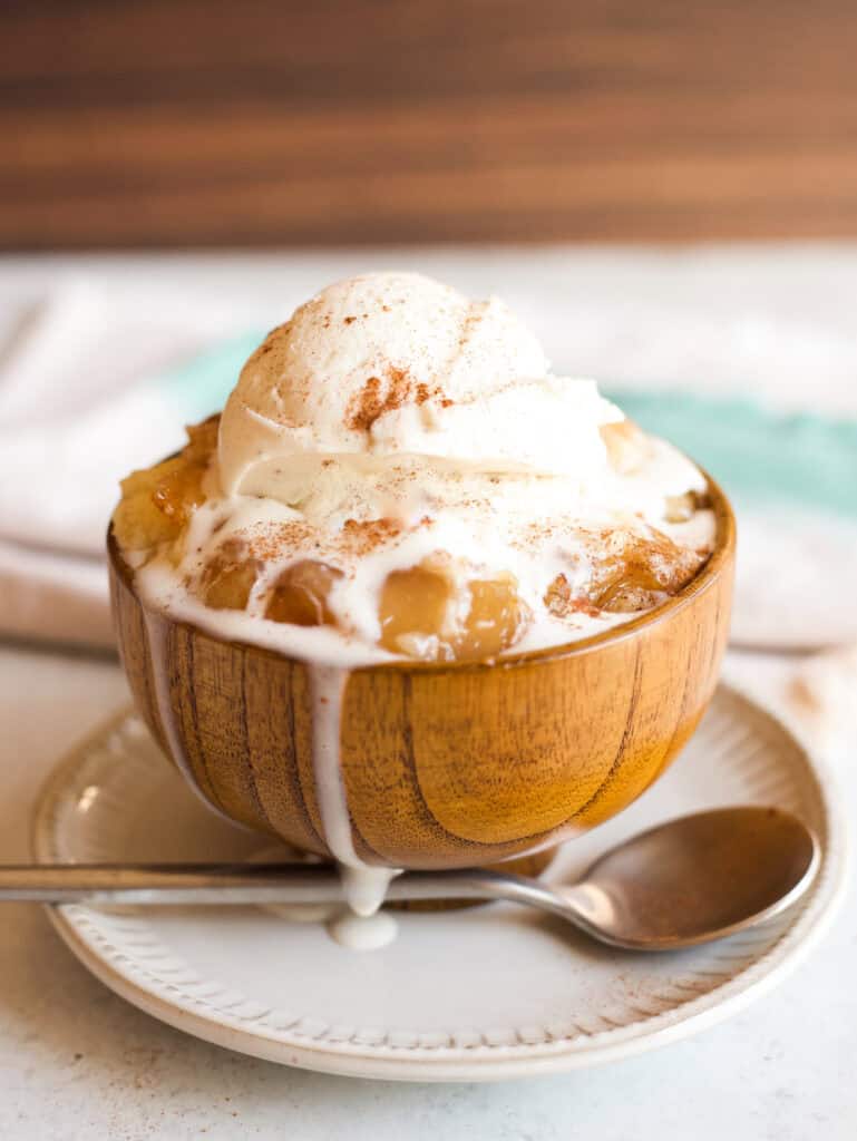 A serving of apple dump cake, topped with vanilla gelato and cinnamon.