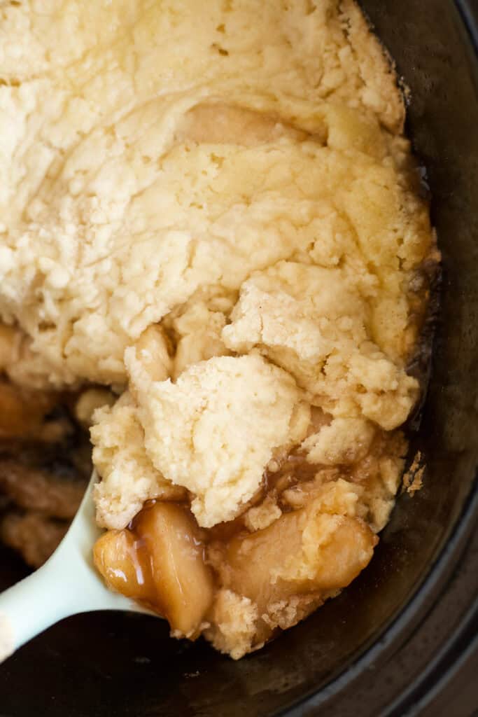 Crockpot full of warm apple cake cobbler.