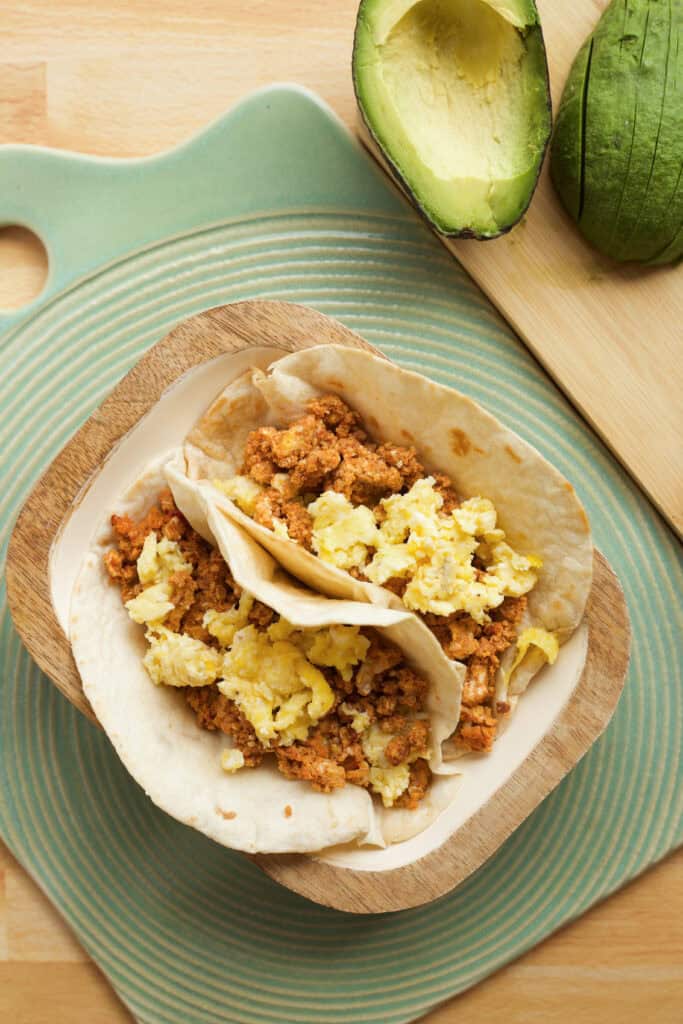 flour tortillas filled with cooked eggs and chorizo