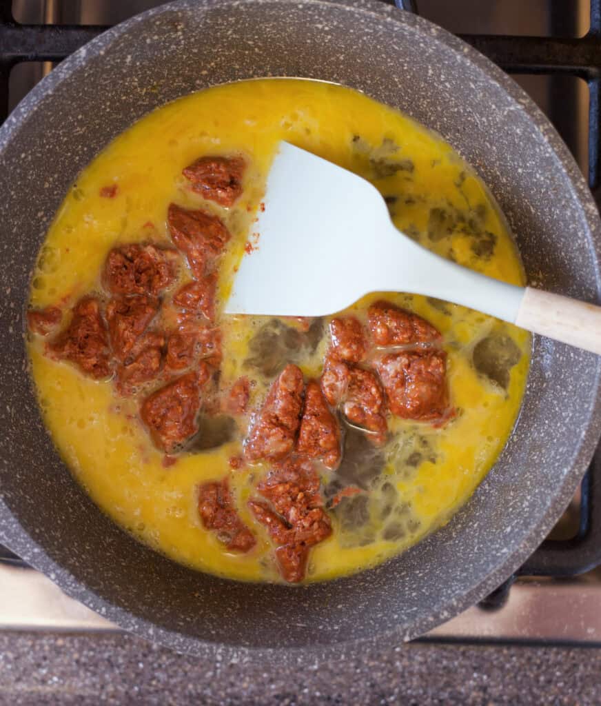 eggs and chorizo cooking in a skillet