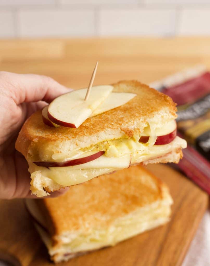 melted cheese, mustard, and apple slices in a grilled cheese sandwich