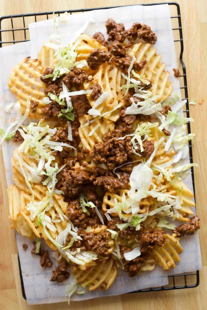 waffle fries topped with seasoned ground beef and shredded lettuce