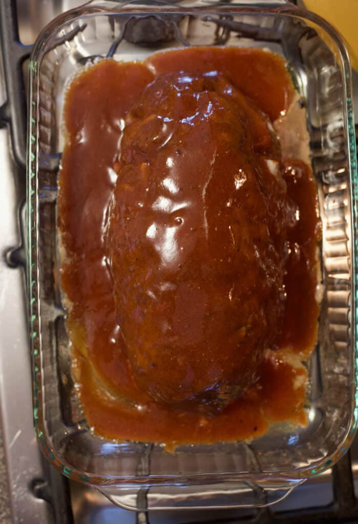 baked meatloaf covered in brown sugar, mustard, and ketchup sauce