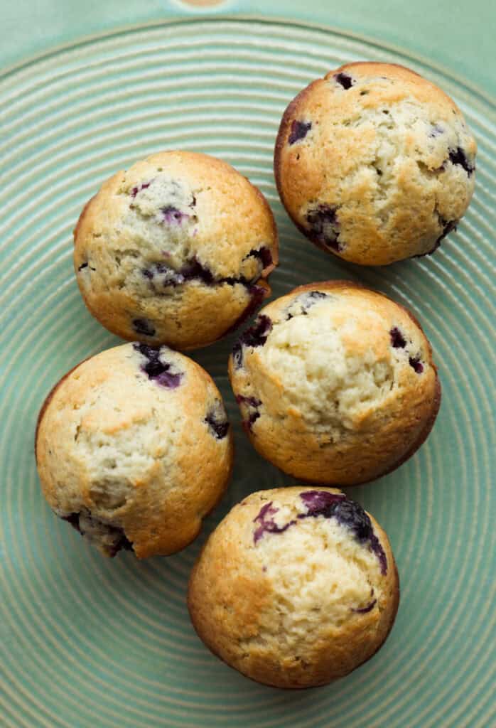 Old-fashioned blueberry muffins on a serving board.