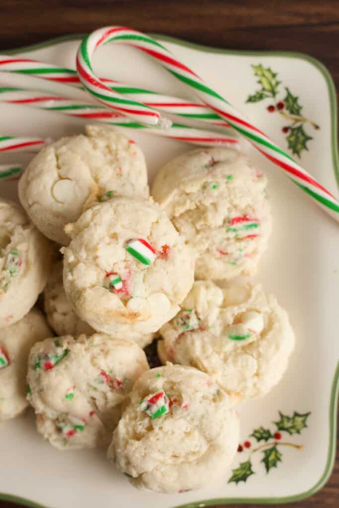 A holiday plate filled with candy canes and Cake Mix Peppermint Cookies.