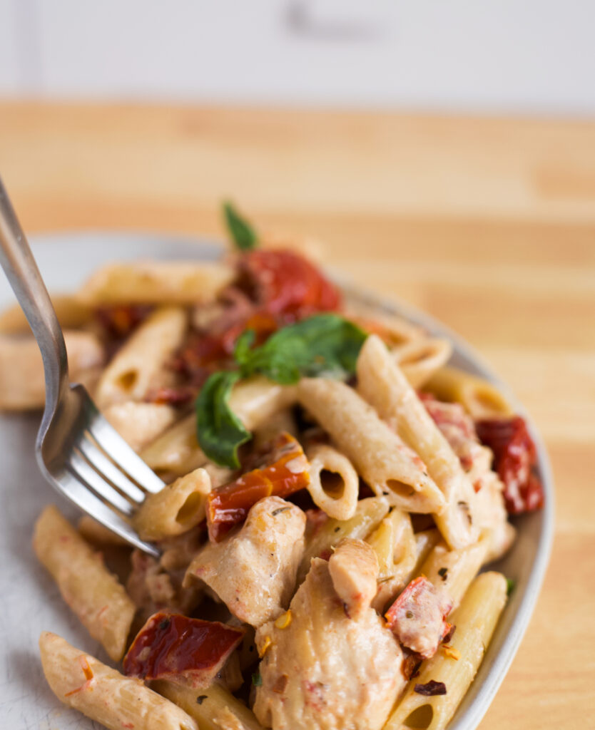 Fork grabbing noodle in Marry Me Chicken Pasta.